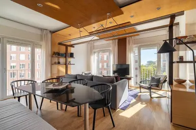 a dining room and living room with a table and chairs at Stay U-nique Apartments Salvador Espriu in Barcelona
