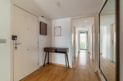 a hallway with a wooden table and a mirror at Stay U-nique Apartments Salvador Espriu in Barcelona