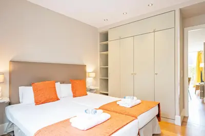 a bedroom with two beds with towels on them at Alcam Olimpic in Barcelona