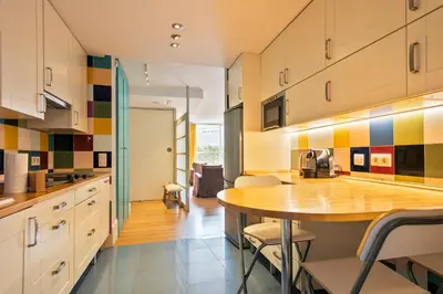 a kitchen with a wooden table and chairs at Alcam Olimpic in Barcelona