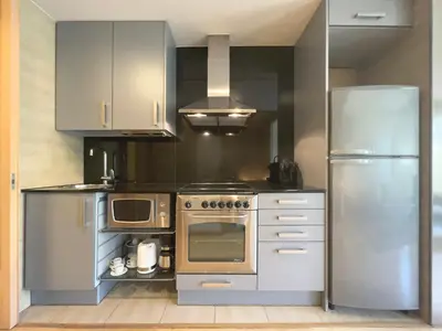 a kitchen with a stainless steel stove and refrigerator at Stay U-nique Apartments Venecuela in Barcelona