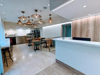 a kitchen and dining room with tables and chairs at Hostal Baler in Barcelona