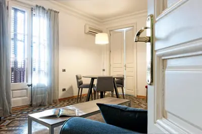 a living room with a table and chairs at MH Apartments Tetuan in Barcelona