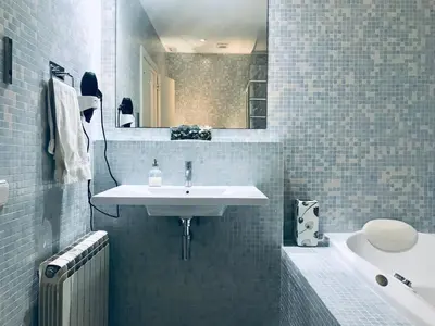 a bathroom with a sink and a mirror and a tub at Enric Granados 17 in Barcelona