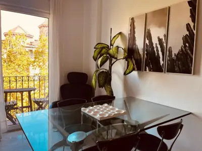 a dining room with a glass table and chairs at Enric Granados 17 in Barcelona