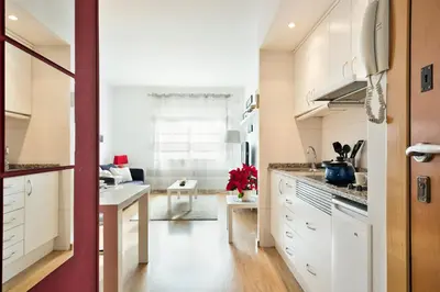 a kitchen with white cabinets and a counter top at Luxury Apartment Barcelona in Barcelona