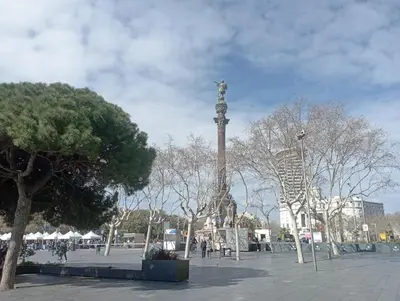 a tall pole with a statue on top of it at Aparthotel Rambla108 in Barcelona
