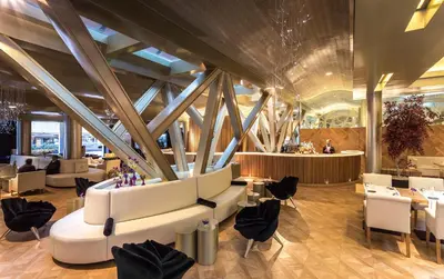 a restaurant with white chairs and tables in a building at Monument Hotel in Barcelona