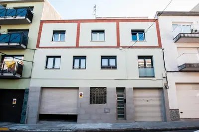 an apartment building with two garages and two garage doors at Cal Negri in Vilafranca del Penedès