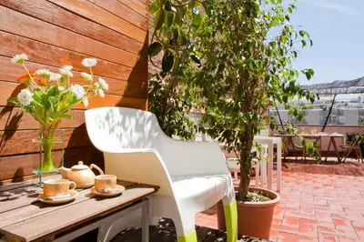 a white chair and a table on a patio at Best deal PENTHOUSE! in Barcelona