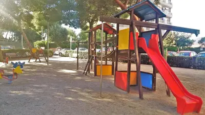 a playground with a slide in a park at Bianca Seaview & Beach Apartment in Montgat