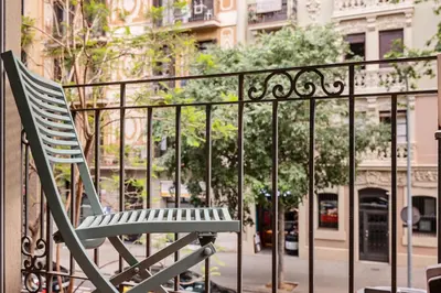 a green chair sitting on a balcony at Sweett - Rosemarine in Barcelona