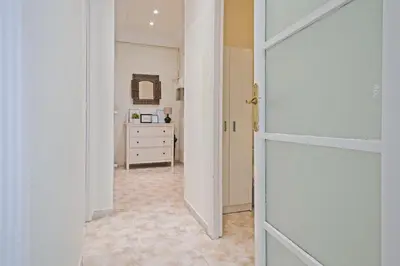 a hallway with a door and a dresser in a room at Apartmento Industria in Barcelona