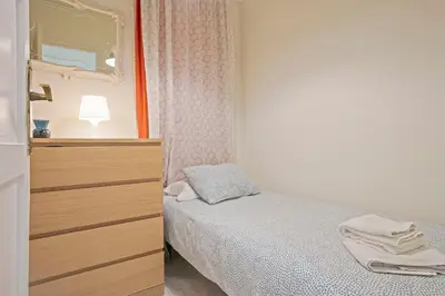 a bedroom with a bed and a dresser with a mirror at Apartmento Industria in Barcelona
