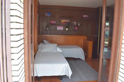 a small room with a bed and a mirror at Duplex Berlin 87 in Barcelona