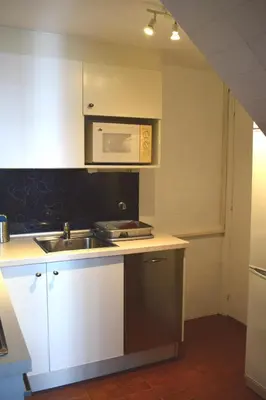 a kitchen with a sink and a microwave at Duplex Berlin 87 in Barcelona