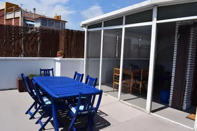 a blue table and chairs on a patio at Duplex Berlin 87 in Barcelona