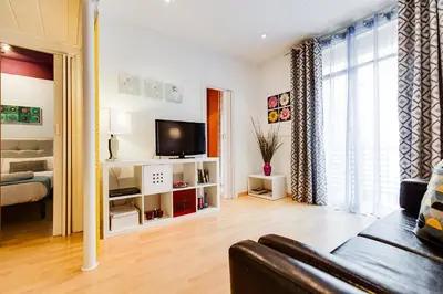 a living room with a couch and a television at Deep Purple in Barcelona