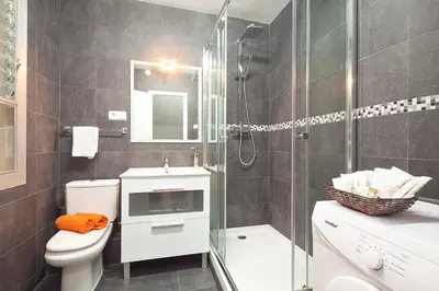 a bathroom with a shower and a toilet and a sink at Deep Purple in Barcelona