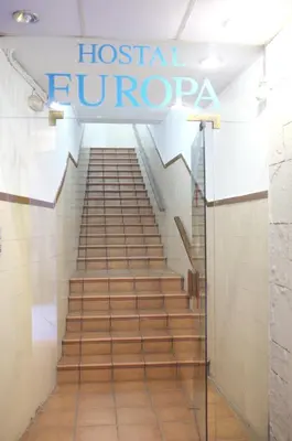 a staircase in a hospital lobby with a sign that reads hospital fluoropapa at Hostal Europa in Barcelona