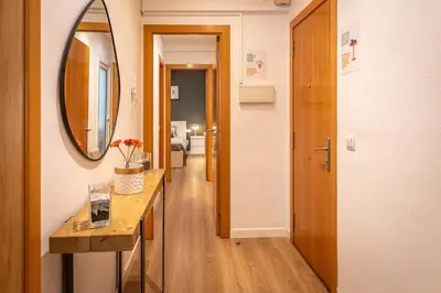 a hallway with a table and a mirror and a hallway with a hallway at Lindo apartamento Vila de Gracia in Barcelona