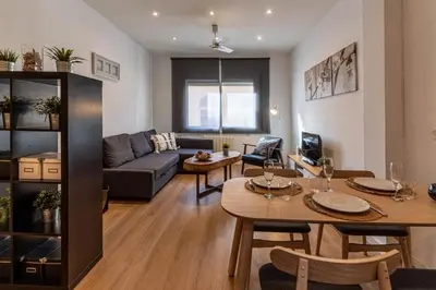 a living room with a couch and a table at Lindo apartamento Vila de Gracia in Barcelona