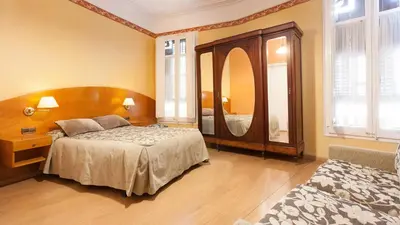 a bedroom with a bed and a mirror at Hostal Oliva in Barcelona