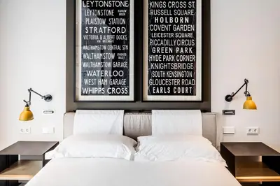 a bedroom with a bed with two night stands and two lamps at Midtown Apartments in Barcelona