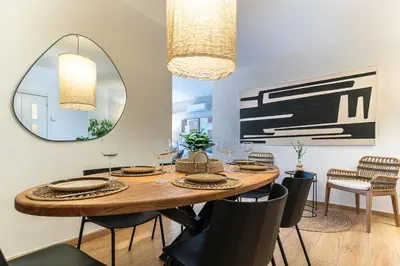 a dining room with a wooden table and a mirror at Gran apartamento Sagrada Familia in Barcelona