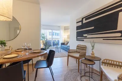 a dining room and living room with a table and chairs at Gran apartamento Sagrada Familia in Barcelona