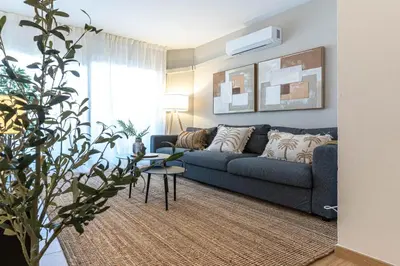 a living room with a blue couch and a table at Gran apartamento Sagrada Familia in Barcelona