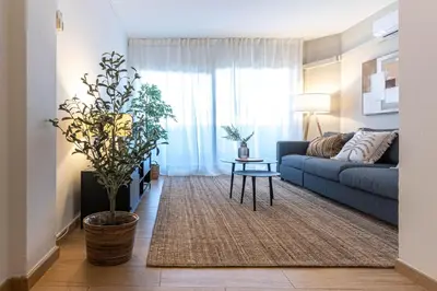 a living room with a blue couch and a table at Gran apartamento Sagrada Familia in Barcelona
