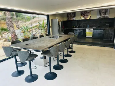 a large wooden table and chairs in a room at Villa Palmera in Olivella