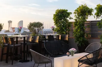 a patio with tables and chairs on a roof at Duquesa Suites Landmark Hotel by Grup Duquessa in Barcelona