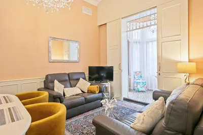 a living room with a couch and a tv at Villa Modernista in Barcelona
