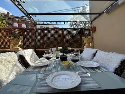 a table with glasses of wine on a patio at Villa Modernista in Barcelona