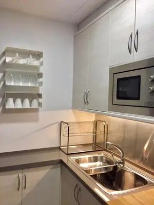 a kitchen with a sink and a microwave at Casas Apartamentos Gracia in Barcelona