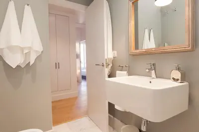a bathroom with a white sink and a mirror at En Casa de Girona 17 in Barcelona