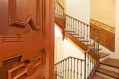 a staircase with wooden railings in a house at En Casa de Girona 17 in Barcelona