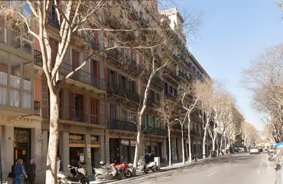 a street with motorcycles parked in front of a building at En Casa de Girona 17 in Barcelona