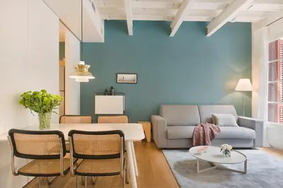 a living room with a table and a couch at En Casa de Girona 17 in Barcelona