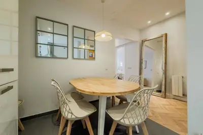 a kitchen and dining room with a table and chairs at Four Petals Barcelona Boutique Apartments in Barcelona
