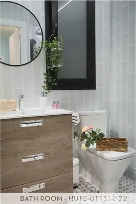 a bathroom with a sink and a mirror and a toilet at Suite Place Barcelona Còrsega in Barcelona