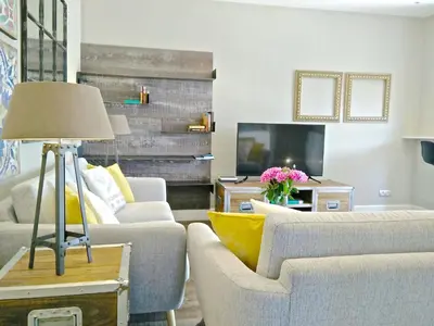 a living room with two couches and a tv at Ferran Pedralbes Penthouse in Barcelona