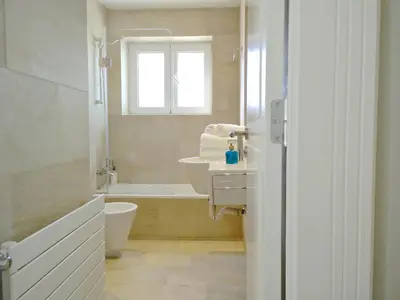 a bathroom with a sink and a bath tub at Ferran Pedralbes Penthouse in Barcelona