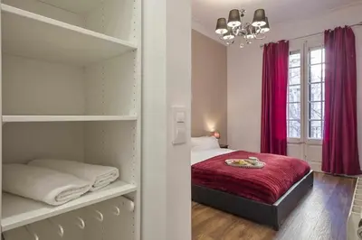 a bedroom with a bed with a red blanket at Apartment Lucia in Barcelona