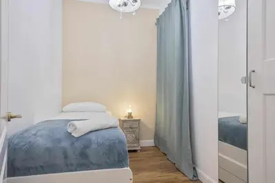 a small bedroom with a bed and a night stand at Apartment Lucia in Barcelona