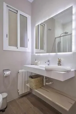 a white bathroom with a sink and a toilet at Apartment Lucia in Barcelona