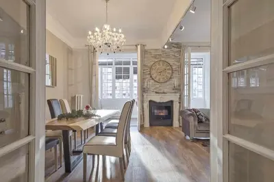 a dining room with a table and a fireplace at Apartment Lucia in Barcelona