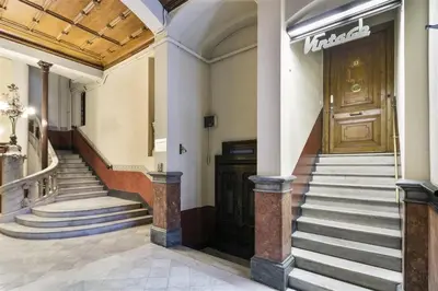 a lobby of a building with stairs and a door at Apartment in downtown Barcelona - Vintage in Barcelona